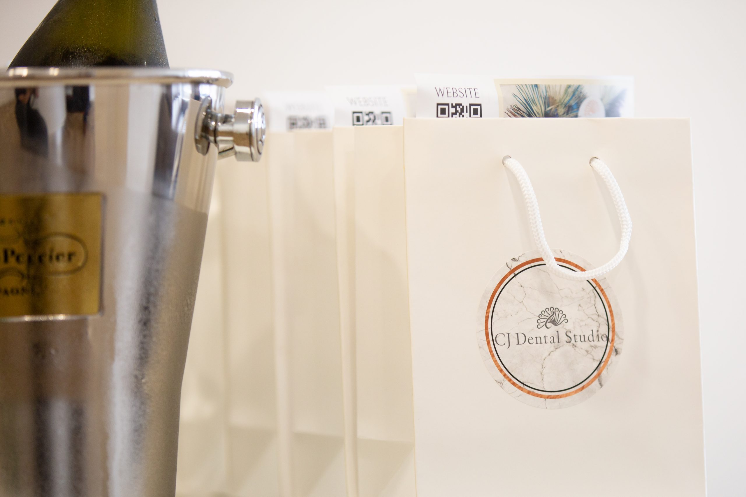CJ Dental Studio official opening photo drinks and goodie bags close up view.